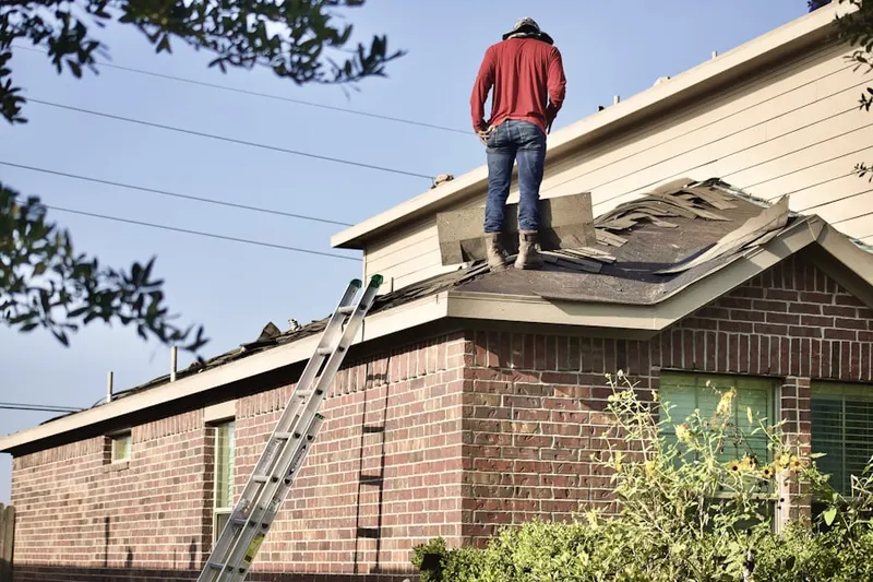 Professional roofer working on a residential roof in Coral